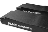 A close up on a pair of black textured MAX RAMPS ramp with a white logo, shown at an angle to display textured surface on a plain white background